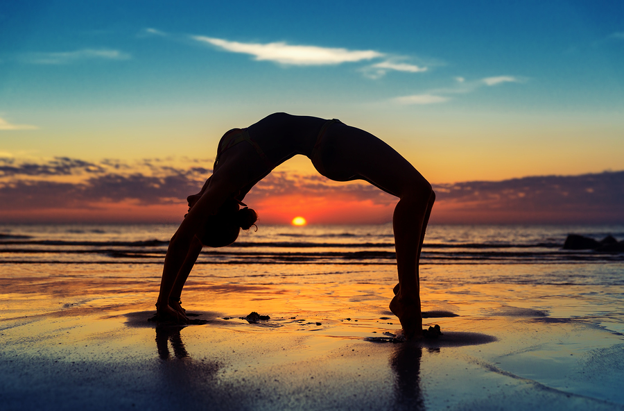 woman exercising at the beach sunrise